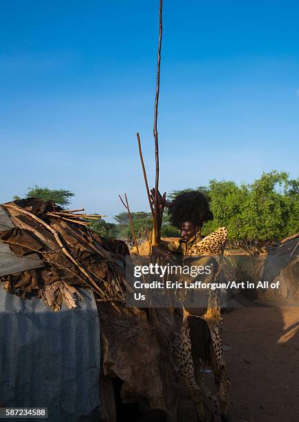 Dassanech man with leopard skin and ostrich feathers headwear during dimi ceremony to celebrate circumcision of teenagers, omo valley, omorate,...