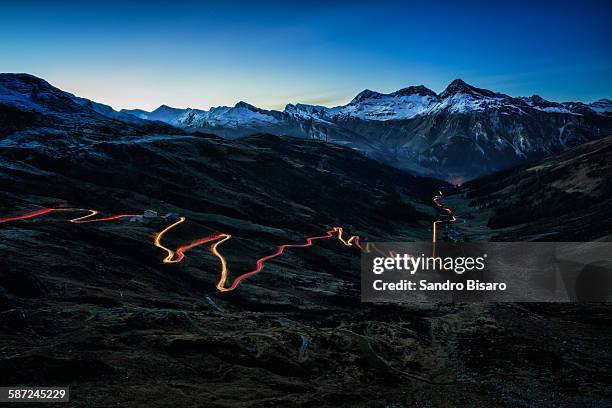 splügen pass at night with traffic lights - light trail nature stock pictures, royalty-free photos & images