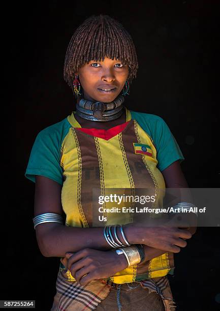 Portrait of a hamer tribe woman with ethiopia football shirt, omo valley, turmi, Ethiopia on March 14, 2016 in Turmi, Ethiopia.