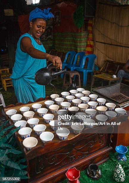Ethiopian woman filled coffe cups in a bar, semien wollo zone, woldia, Ethiopia on February 24, 2016 in Woldia, Ethiopia.