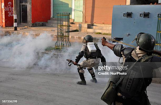 Indian Paramilitary personal uses a sling shot during clashes after lifting the curfew in old city srinagar on August 8,2016.The protests have...