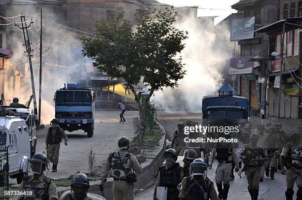 Kashmiri protester chase indian Paramilitary forces after they lift the curfew in old city srinagar on August 8,2016.The protests have entered second...