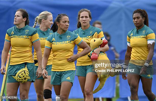 Australia's Evania Pelite carries a boxing kangaroo stuffed toy after victory in the womens rugby sevens semi-final match between Australia and...