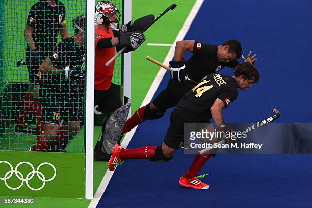 David Carter, Adam Froese, and Matthew Sarmento of Canada run out of the goal against Argentina during a Men's Pool A match on Day 3 of the Rio 2016...