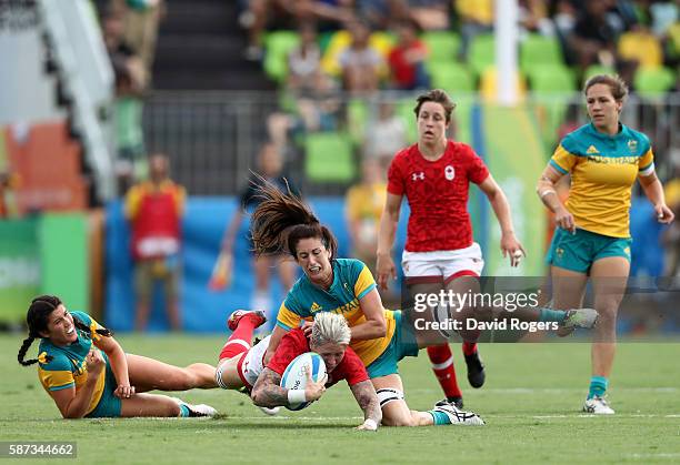 Jennifer Kish of Canada gets tackled during the Women's Semi Final 1 Rugby Sevens match between Australia and Canada on Day 3 of the Rio 2016 Olympic...