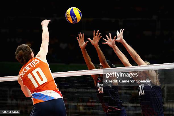 Foluke Akinradewo of United States and Jordan Larson-Burbach of United States defend a shot by Lonneke Sloetjes of Netherlands on Day 3 of the Rio...