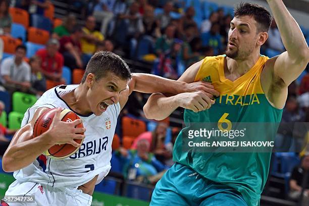 Serbia's shooting guard Bogdan Bogdanovic works around Australia's centre Andrew Bogut during a Men's round Group A basketball match between Serbia...