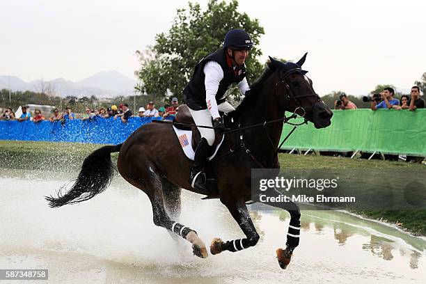 Phillip Dutton of the United States riding Mighty Nice competes during the Cross Country Eventing on Day 3 of the Rio 2016 Olympic Games at the...