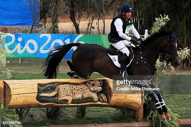 Phillip Dutton of the United States riding Mighty Nice clears a jump during the Cross Country Eventing on Day 3 of the Rio 2016 Olympic Games at the...