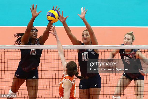 Foluke Akinradewo of United States and Jordan Larson-Burbach of United States block a shot during the Women's Preliminary Pool B match between the...