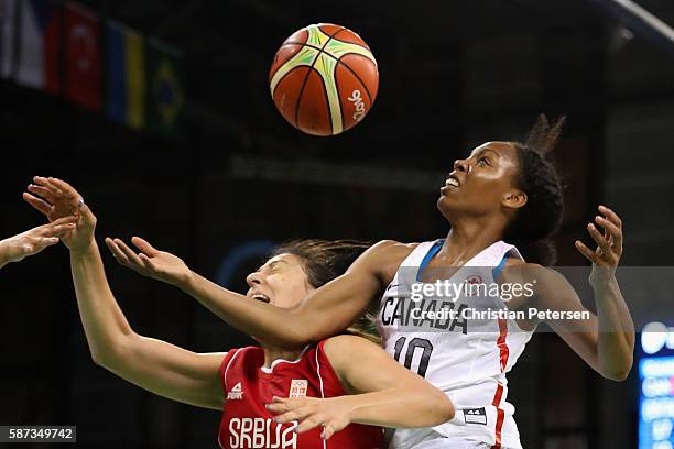 Nirra Fields of Canada and Jelena Milovanovic of Serbia battle for a loose ball during the women's basketball game on Day 3 of the Rio 2016 Olympic...