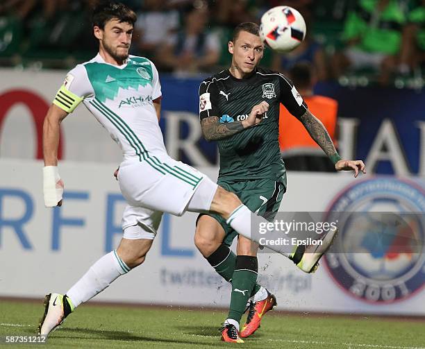 Pavel Mamaev of FC Krasnodar is challenged by Rizvan Utsiyev of FC Terek Grozny during the Russian Premier League match between FC Krasnodar v FC...