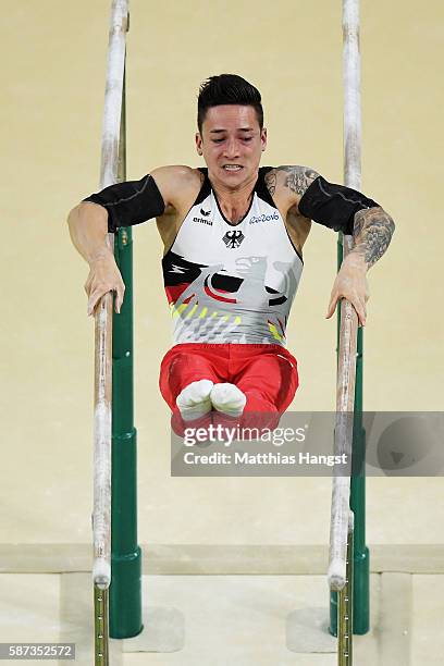 Marcel Nguyen of Germany competes on the parallel bars during the men's team final on Day 3 of the Rio 2016 Olympic Games at the Rio Olympic Arena on...