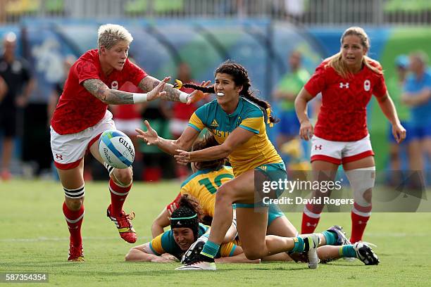 Charlotte Caslick of Australia passes the ball during the Women's Semi Final 1 Rugby Sevens match between Australia and Canada on Day 3 of the Rio...