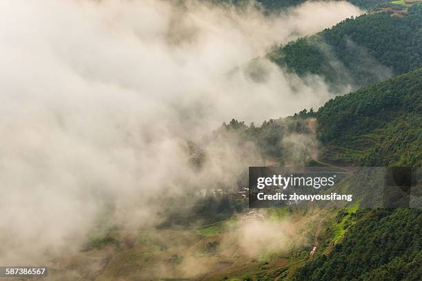 the village in fog - yunnan province stock pictures, royalty-free photos & images