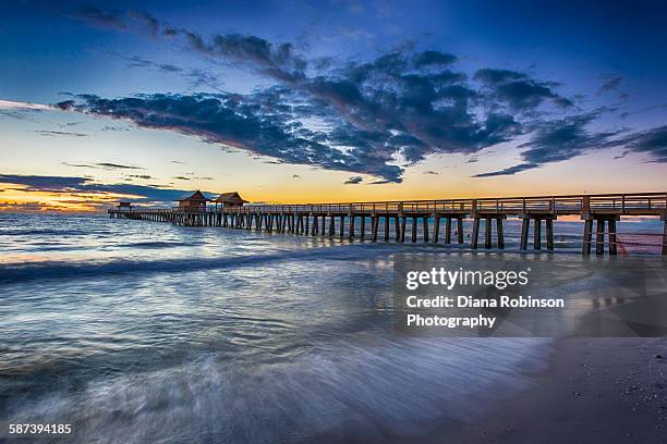 sunset over naples pier, naples, florida - naples pier stock pictures, royalty-free photos & images