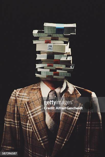 Man with stacks of US banknotes for a head, circa 1985.