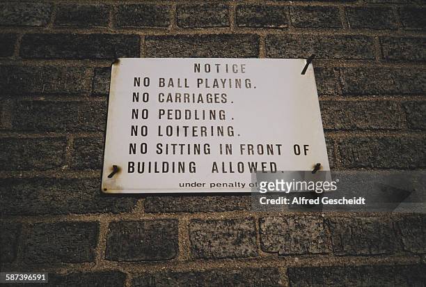 Prohibitive sign in New York City, 1993. It reads 'Notice. No Ball Playing. No Carriages. No Peddling. No Loitering.No Sitting in Front of Building...