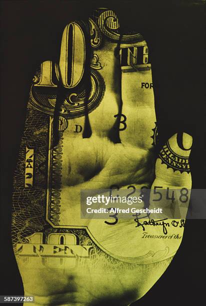 Human hand with a 10 dollar bill superimposed on it, circa 1985.