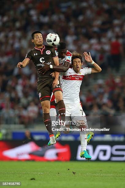 Ryo Miyaichi of St. Pauli jumos for a headder with Stephen Sema and Hajime Hosogai of Stuttgart during the Second Bundesliga match between VfB...
