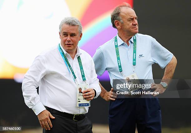 International Golf Federation Vice President Ty Votaw and President Peter Dawson wait on a green during a practice round during Day 3 of the Rio 2016...