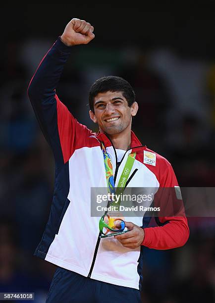 Bronze medalist Lasha Shavdatuashvili of Georgia celebrates on the podium after the Men's -73 kg Judo contest on Day 3 of the Rio 2016 Olympic Games...