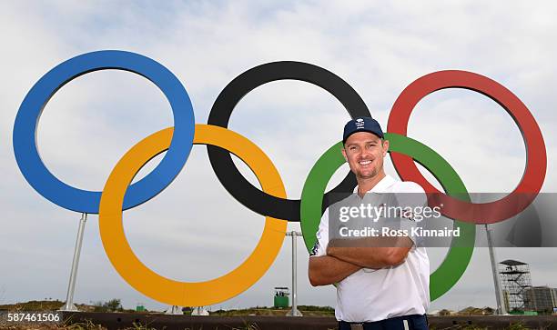 Justin Rose of Great Britain in front of a set of Olympic rings during a practice round at Olympic Golf Course on August 8, 2016 in Rio de Janeiro,...