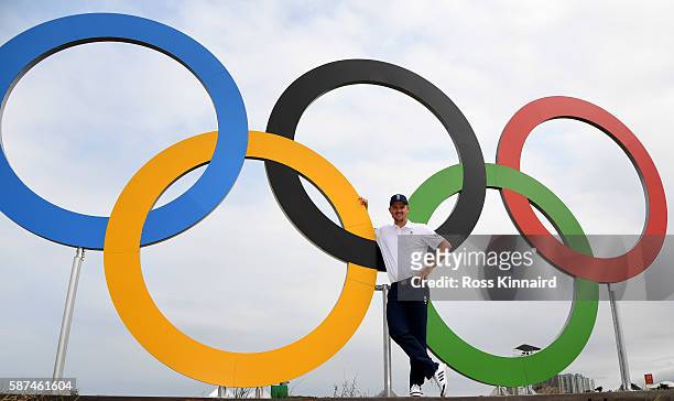 Justin Rose of Great Britain in front of a set of Olympic rings during a practice round at Olympic Golf Course on August 8, 2016 in Rio de Janeiro,...