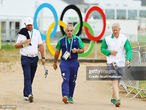 Team leader Paul McGinley walks with Padraig Harrington and Harrington's caddie Ronan Flood during a practice round during Day 3 of the Rio 2016...