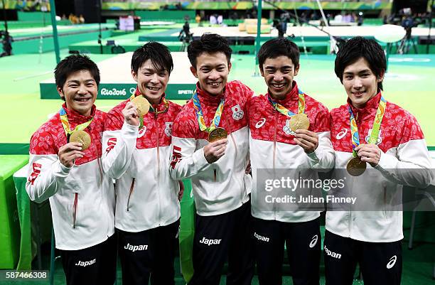 Gold medalists Koji Yamamuro, Kohei Uchimura, Yusuke Tanaka, Kenzo Shirai and Ryohei Kato of Japan pose for photogrpahs with their medals at the...