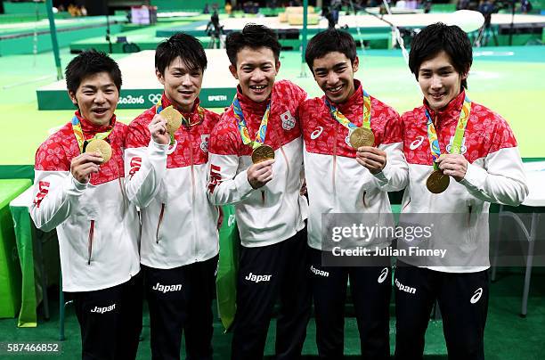 Gold medalists Koji Yamamuro, Kohei Uchimura, Yusuke Tanaka, Kenzo Shirai and Ryohei Kato of Japan pose for photogrpahs with their medals at the...