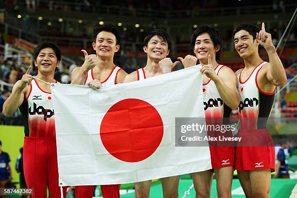 Koji Yamauro, Yusuke Tanaka, Kohei Uchimura, Ryohei Kato and Kenzo Shirai of Japan pose for photographs after winning the gold medal during the men's...