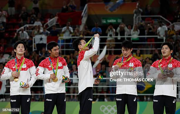 Japan's Ryohei Kato, Japan's Kenzo Shirai, Japan's Yusuke Tanaka, Japan's Kohei Uchimura and Japan's Koji Yamamuro pose with their gold medals on the...