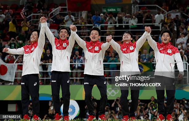 Japan's Ryohei Kato, Japan's Kenzo Shirai, Japan's Yusuke Tanaka, Japan's Kohei Uchimura and Japan's Koji Yamamuro pose with their gold medals on the...