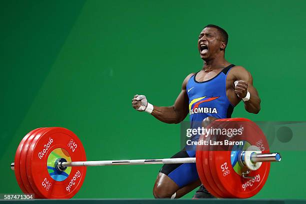 Oscar Albeiro Figueroa Mosquera of Colombia reacts during the Men's 62kg Group A weightlifting contest on Day 3 of the Rio 2016 Olympic Games at the...