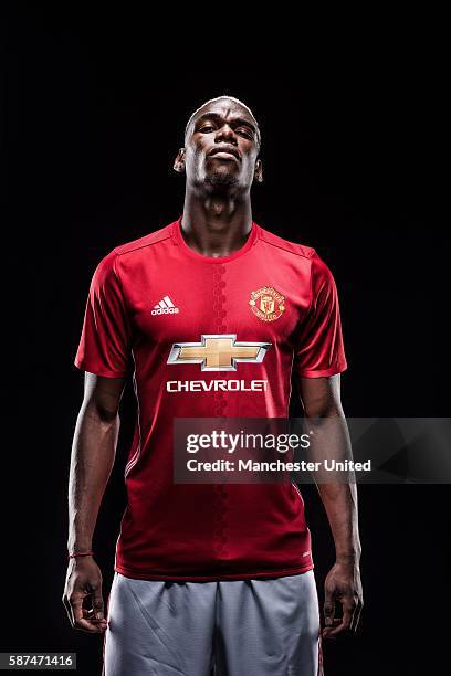 Paul Pogba of Manchester United poses after signing for the club at Aon Training Complex on August 8, 2016 in Manchester, England.