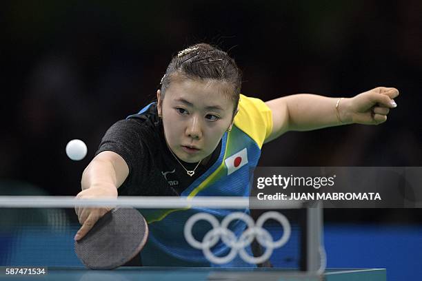 Japan's Ai Fukuhara plays against North Korea's Ri Myong Sun during their women's singles qualification round table tennis match at the Riocentro...