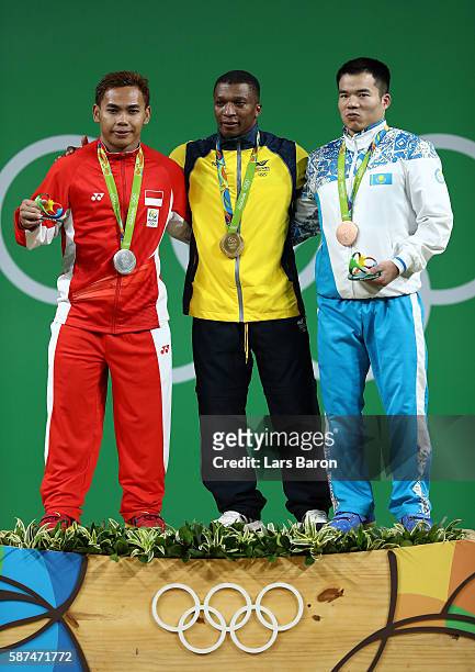 Silver medalist Eko Yuli Irawan of Indonesia, gold medalist Oscar Albeiro Figueroa Mosquera of Colombia and bronze medalist Farkhad Kharki of...