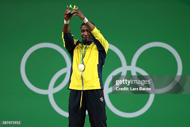 Gold medalist Oscar Albeiro Figueroa Mosquera of Colombia celebrates on the podium during the medal presentation for the Men's 62kg Group A...