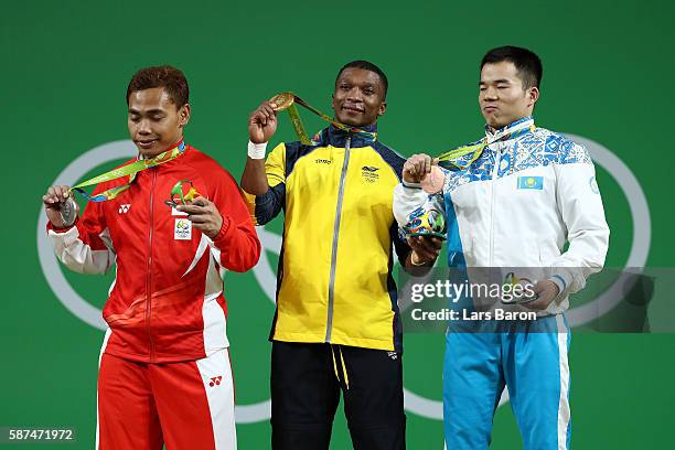 Silver medalist Eko Yuli Irawan of Indonesia, gold medalist Oscar Albeiro Figueroa Mosquera of Colombia and bronze medalist Farkhad Kharki of...