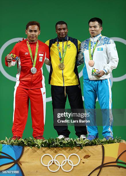 Silver medalist Eko Yuli Irawan of Indonesia, gold medalist Oscar Albeiro Figueroa Mosquera of Colombia and bronze medalist Farkhad Kharki of...