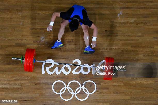 Farkhad Kharki of Kazakhstan loses his balance during the Men's 62kg Group A weightlifting contest on Day 3 of the Rio 2016 Olympic Games at the...
