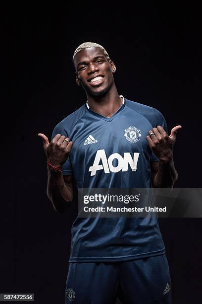 Paul Pogba of Manchester United poses after signing for the club at Aon Training Complex on August 8, 2016 in Manchester, England.