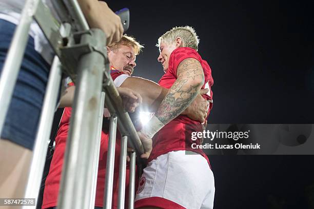 Canadian Olympic rugby captain Jennifer Kish embraces her father Steve in the stands after winning a bronze medal. The Canadian sevens rugby team...