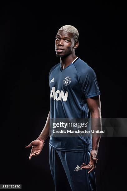 Paul Pogba of Manchester United poses after signing for the club at Aon Training Complex on August 8, 2016 in Manchester, England.