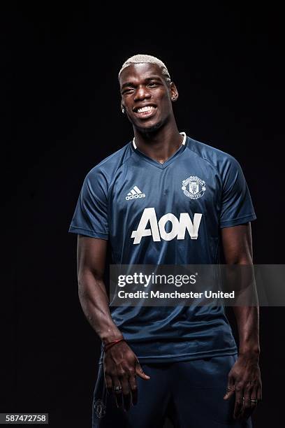 Paul Pogba of Manchester United poses after signing for the club at Aon Training Complex on August 8, 2016 in Manchester, England.