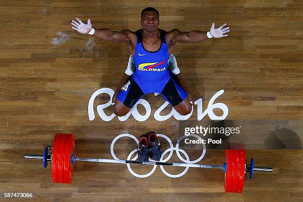 Oscar Albeiro Figueroa Mosquera of Colombia reacts during the Men's 62kg Group A weightlifting contest on Day 3 of the Rio 2016 Olympic Games at the...