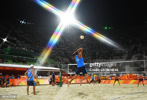 Italy's Alex Ranghieri serves the ball during the men's beach volleyball qualifying match between Italy and Canada at the Beach Volley Arena in Rio...