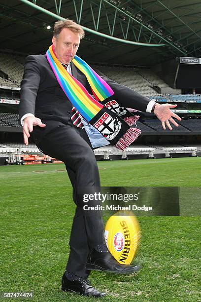 St.Kilda Saints CEO Matt Finnis wears the Pride Game rainbow scarf while he kicks the ball during an AFL media opportunity at Etihad Stadium on...