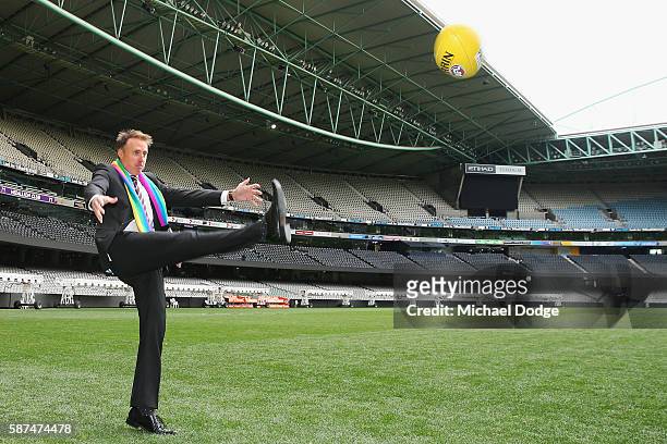 St.Kilda Saints CEO Matt Finnis wears the Pride Game rainbow scarf while he kicks the ball during an AFL media opportunity at Etihad Stadium on...